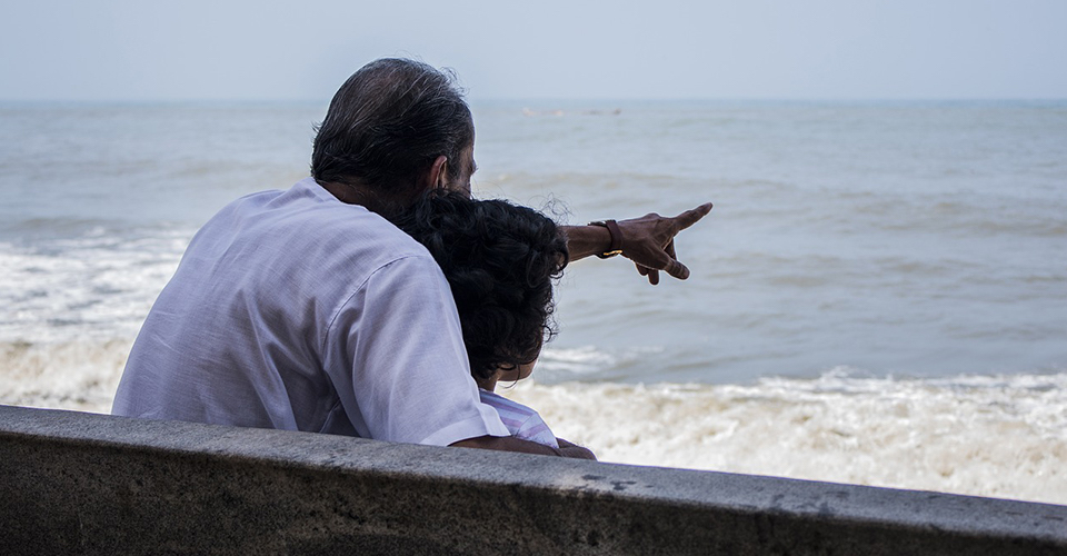 grandfather pointing into sea